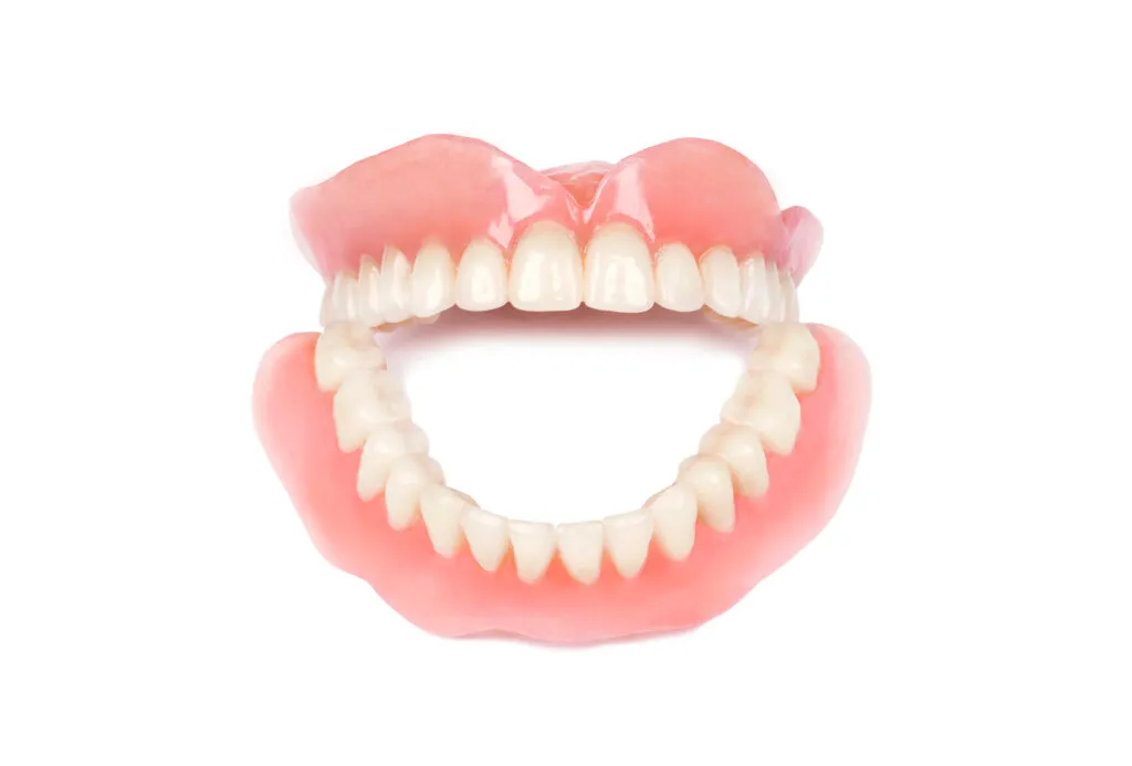 Medical full dentures on white background