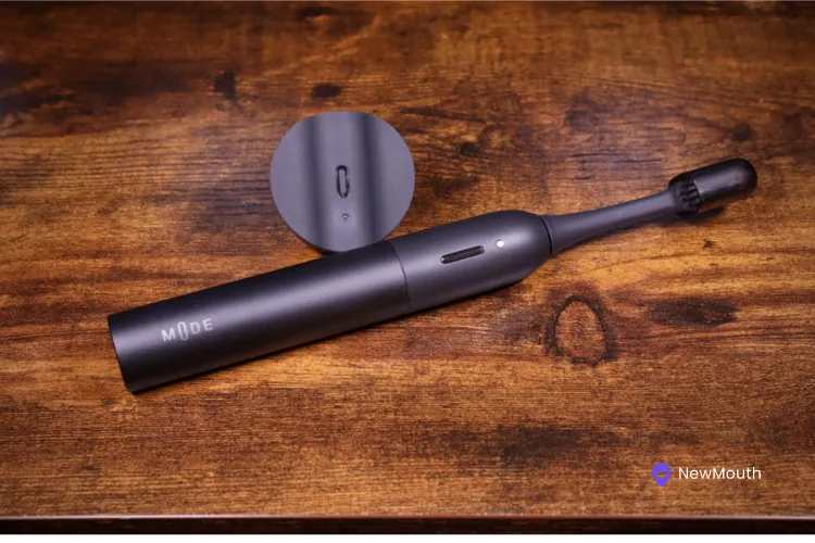 Mode toothbrush with multiple features product shot on wooden table