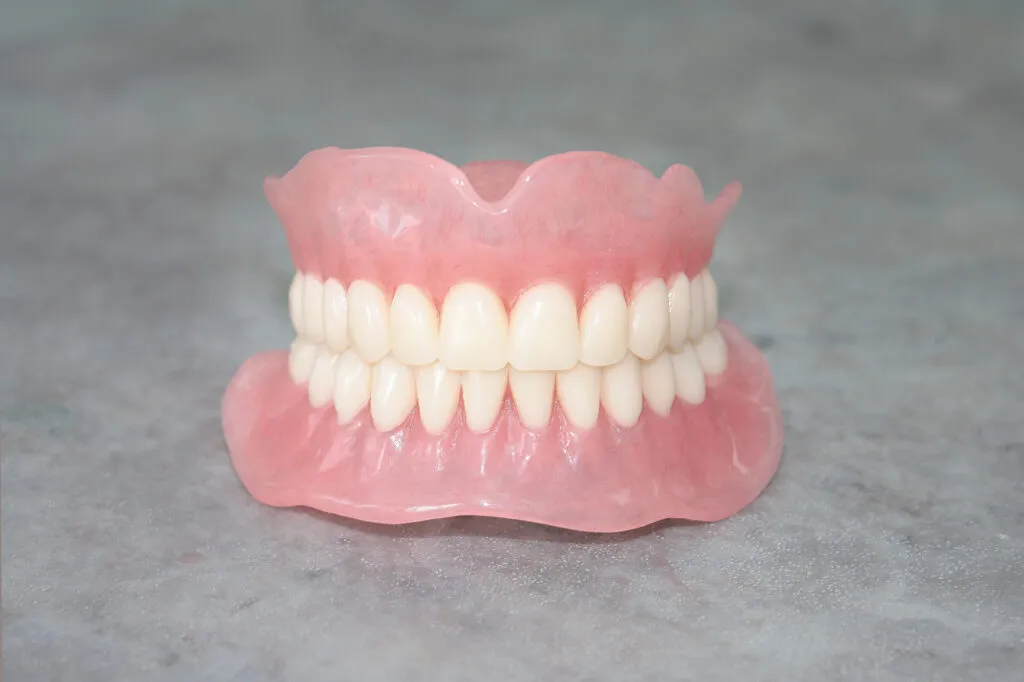 Removable full dentures pictured on clean table
