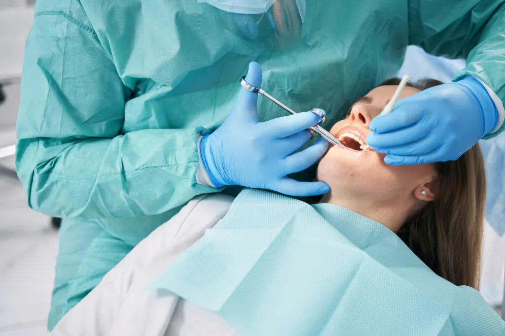 Woman receiving dental local anesthesia or sedation in dentist office