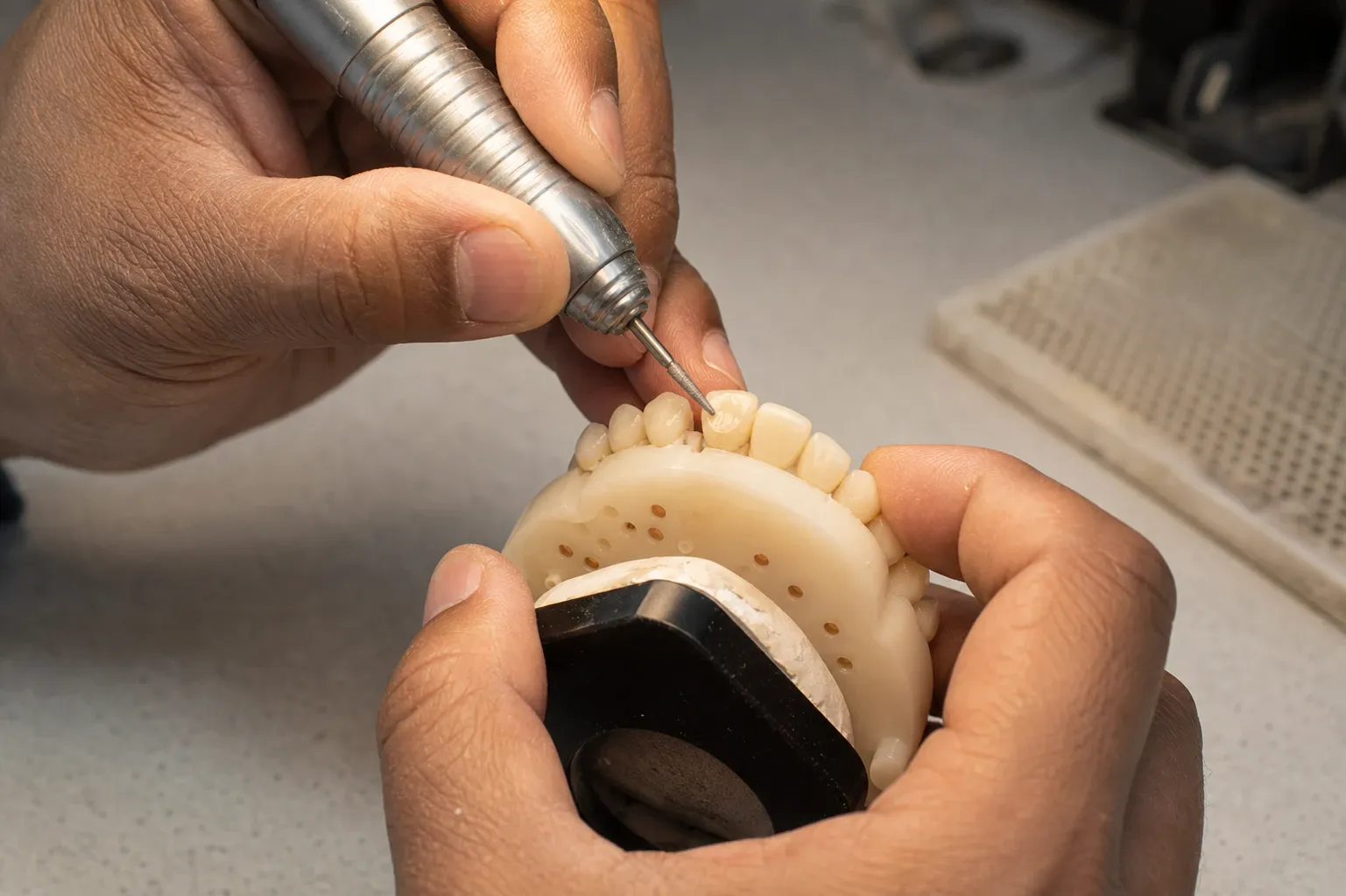 A cropped shot on a man producing a set of dentures nm 1144