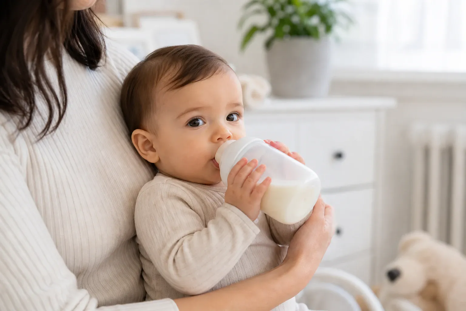 Baby drinking milk from a bottle nm 0357