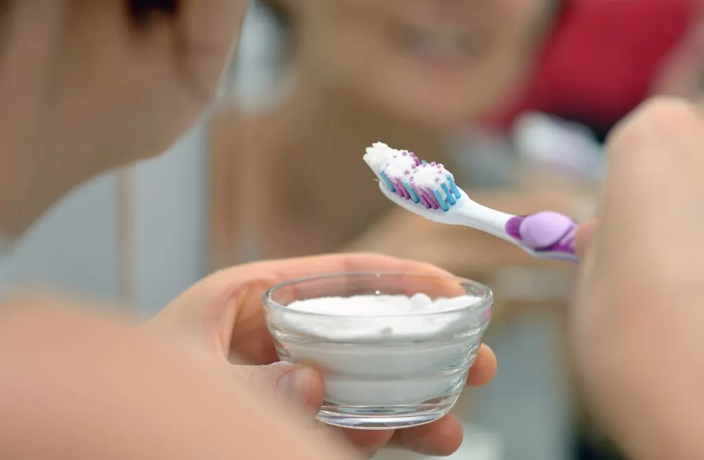 Close up woman preparing brightening teeth with sodium bicarbonate