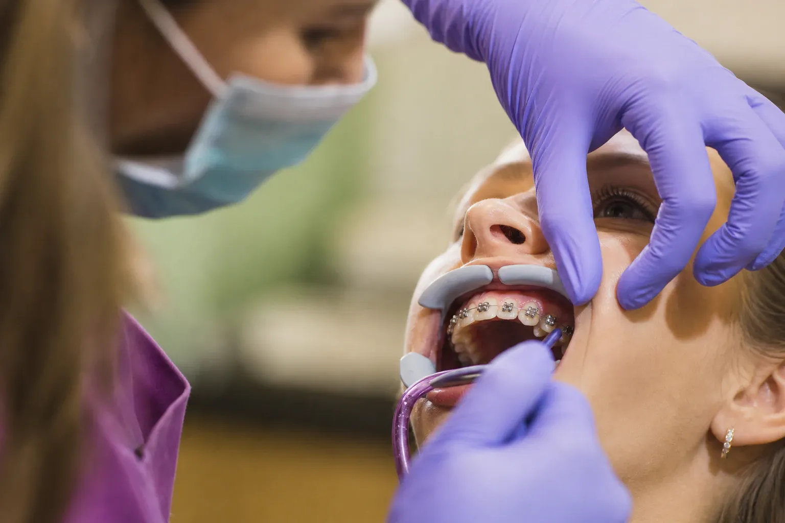 Dentist adjusting patients braces nm 0399