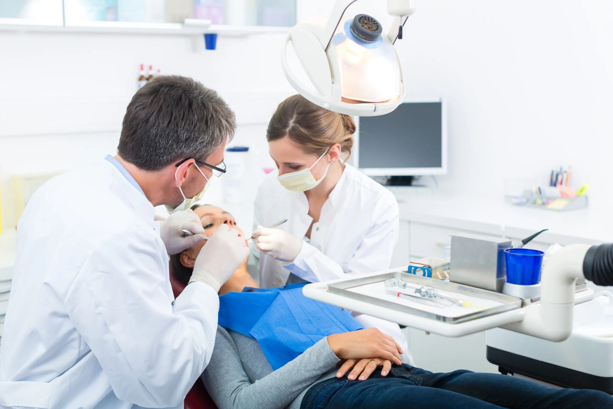 Dentist and assistant during a dental treatment on a patient