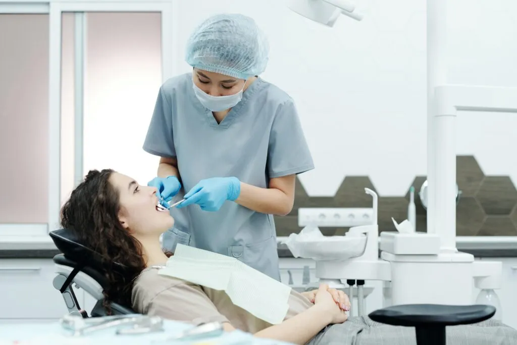 Dentist examining young womans teeth