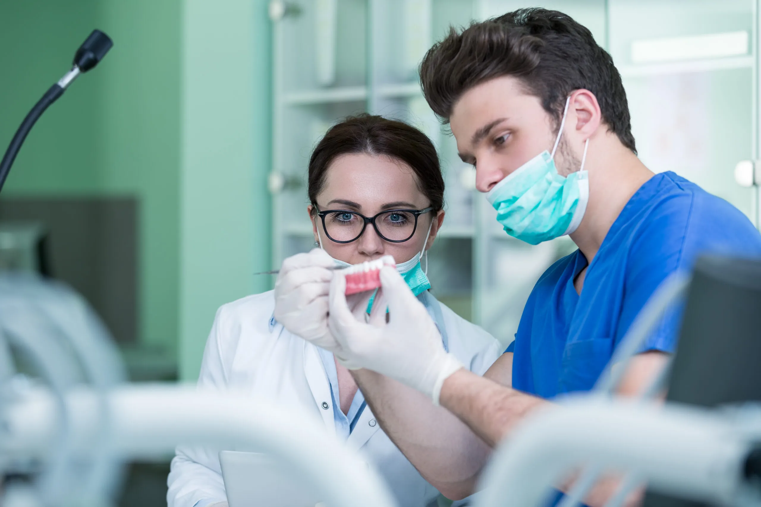 Dentists perfecting a denture in a clinic 1