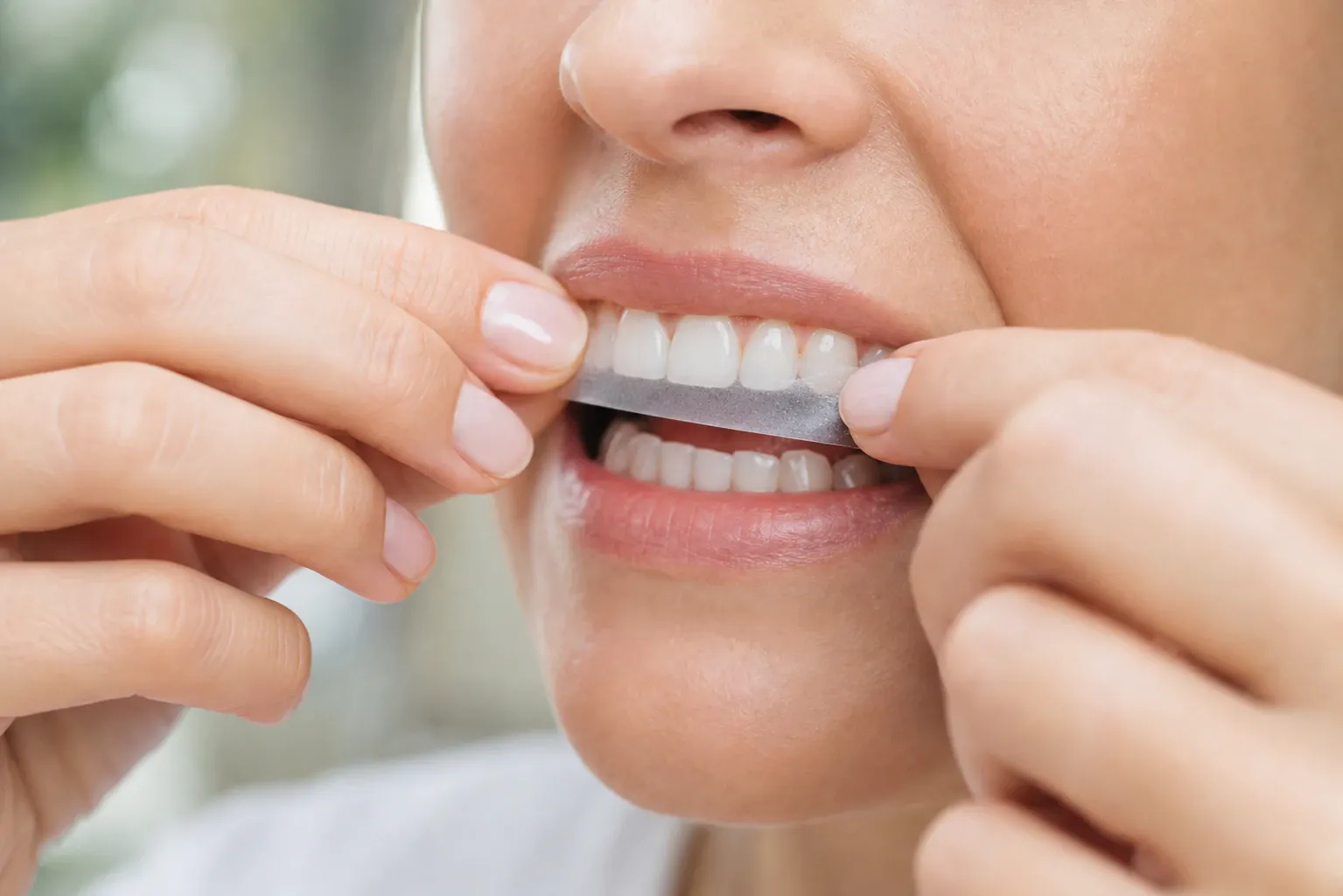 Person applying whitestrips nm 0493