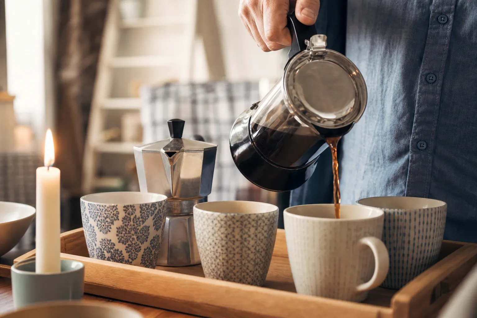 Person pouring coffee into mug nm 0138