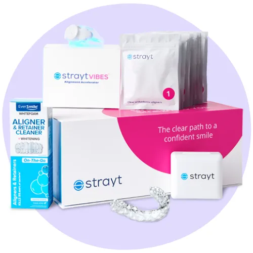 Dental alignment kit with trays, aligner cleaner, and storage case, displayed in front of boxes labeled "strayt.