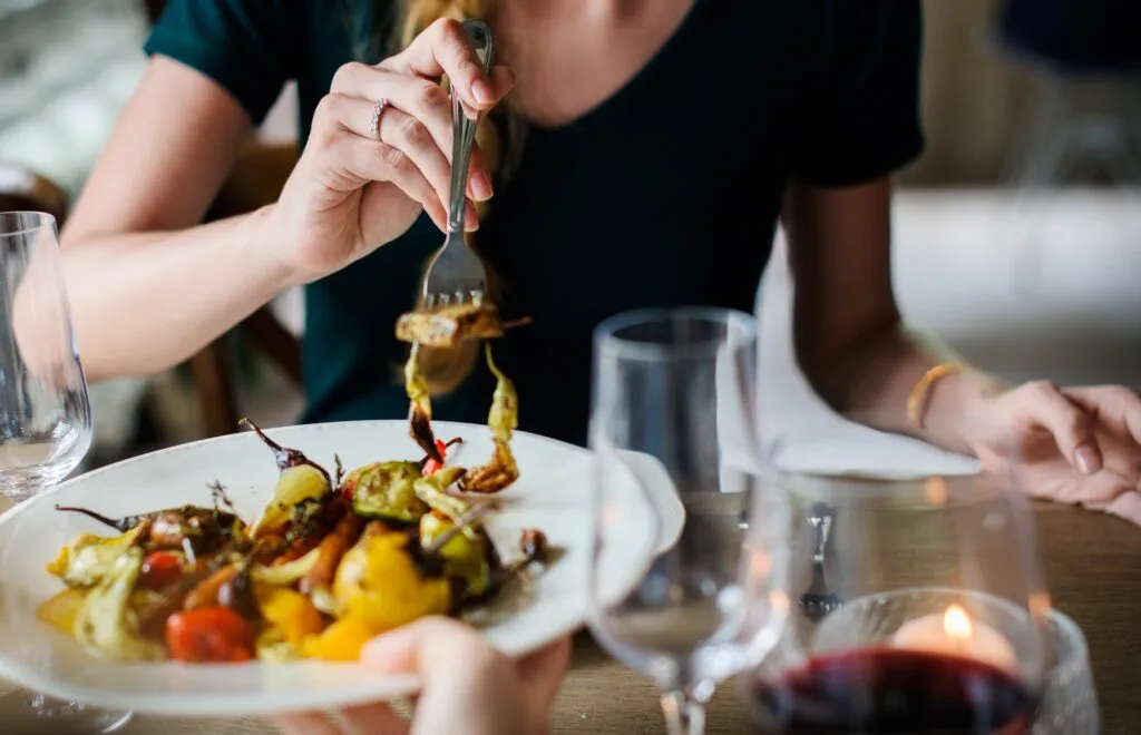 Woman getting food from a plate