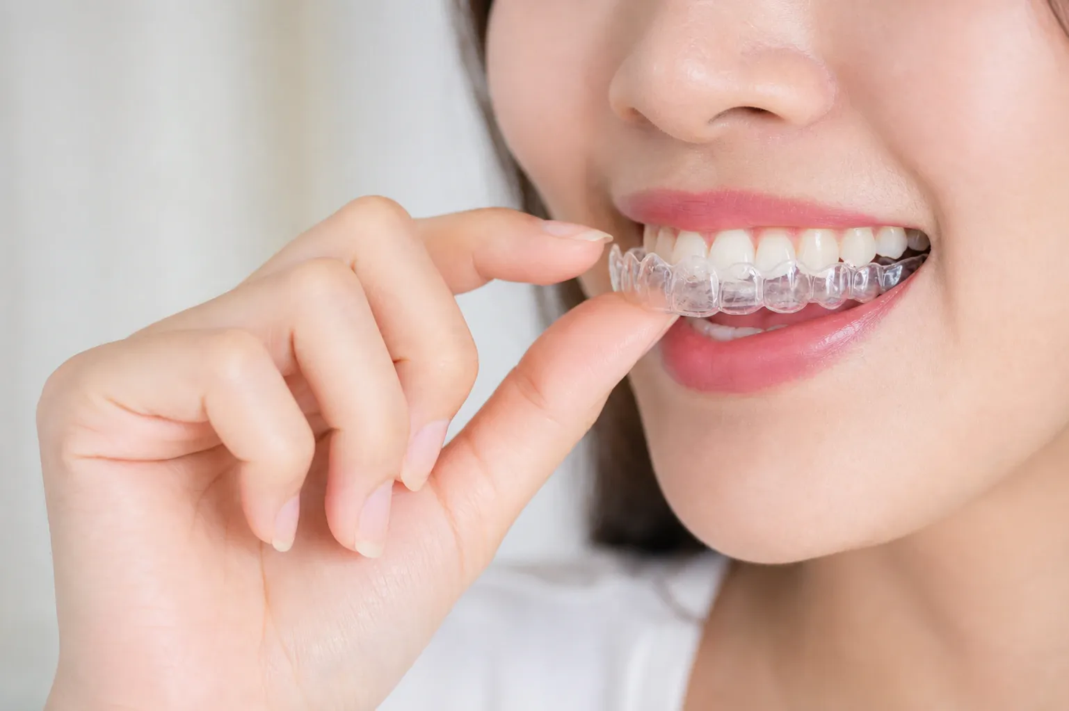 Woman holding clear aligners nm 0100