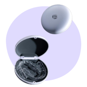 A pair of clear dental aligners in an open round case, with a closed case above, set against a light purple circle background.
