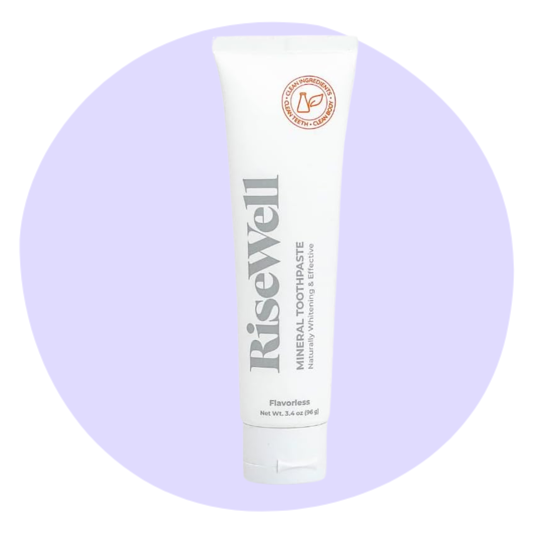 A white tube of RiseWell mineral toothpaste, labeled “Flavorless,” is shown upright against a light purple circular background.